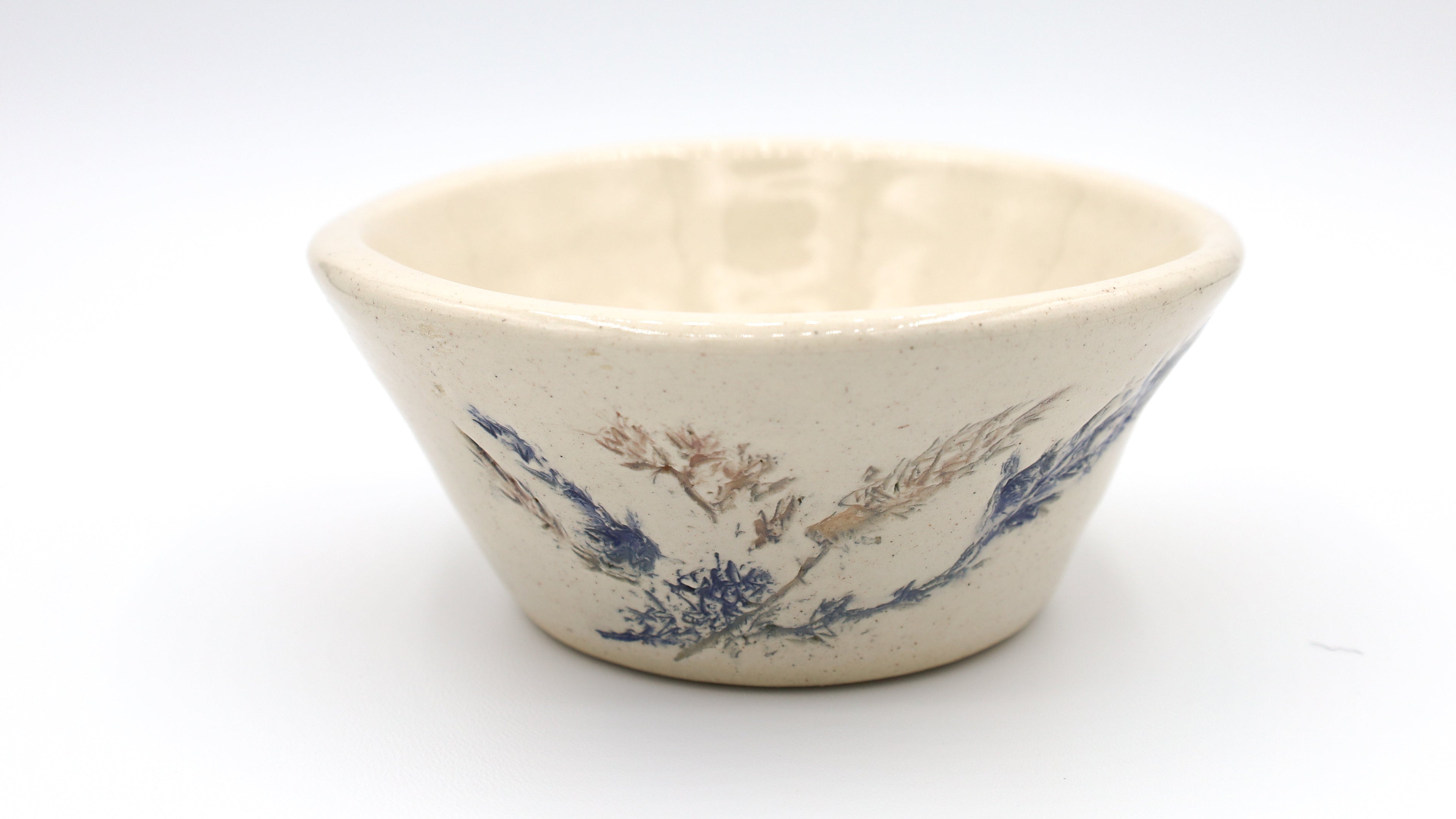 Ceramic bowl with blue floral pattern on a white background